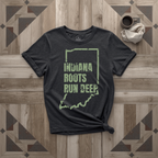 Indiana Roots Run Deep tee in black with sage print, laid flat on weathered wood