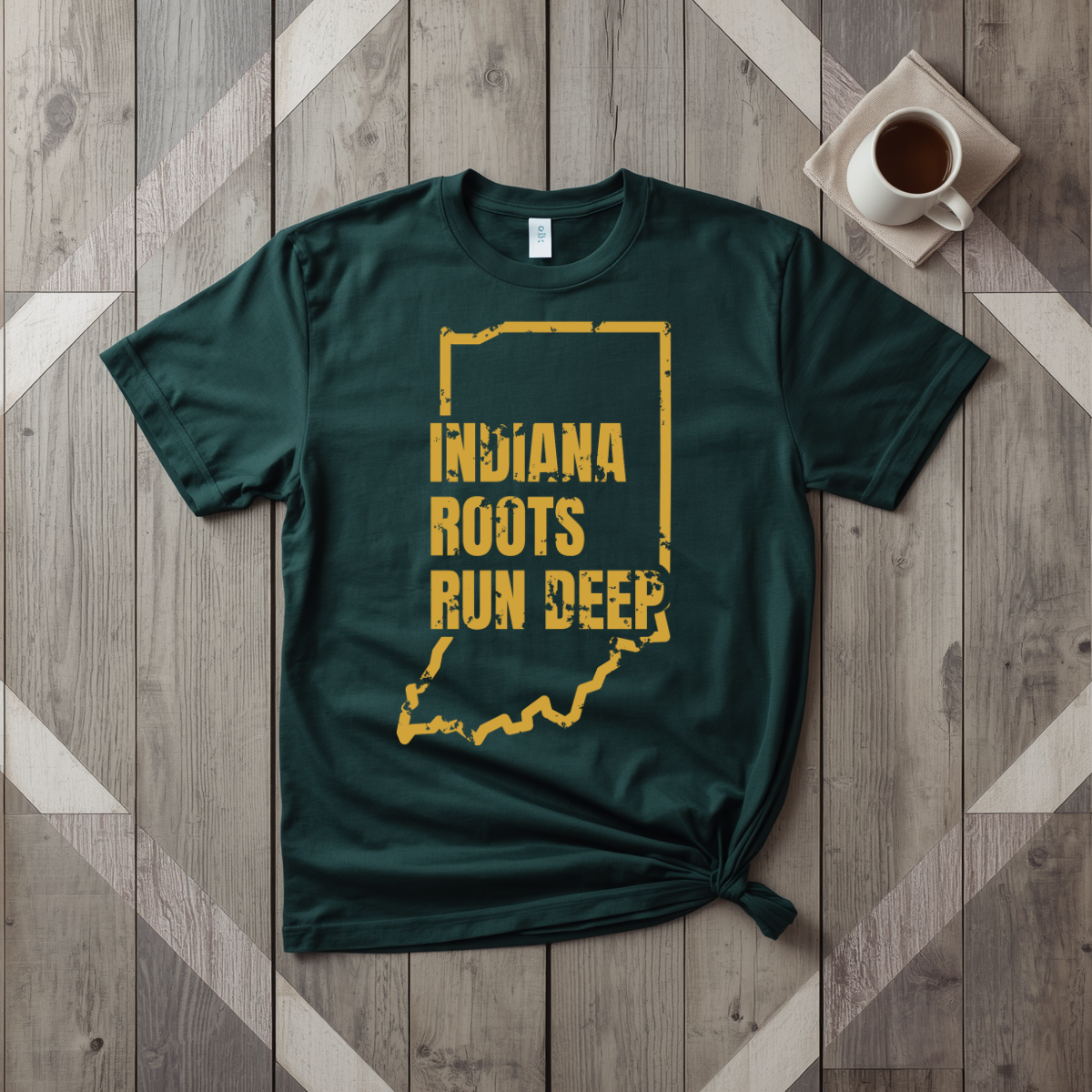 Indiana Roots Run Deep tee in forest green with mustard print, laid flat on weathered wood