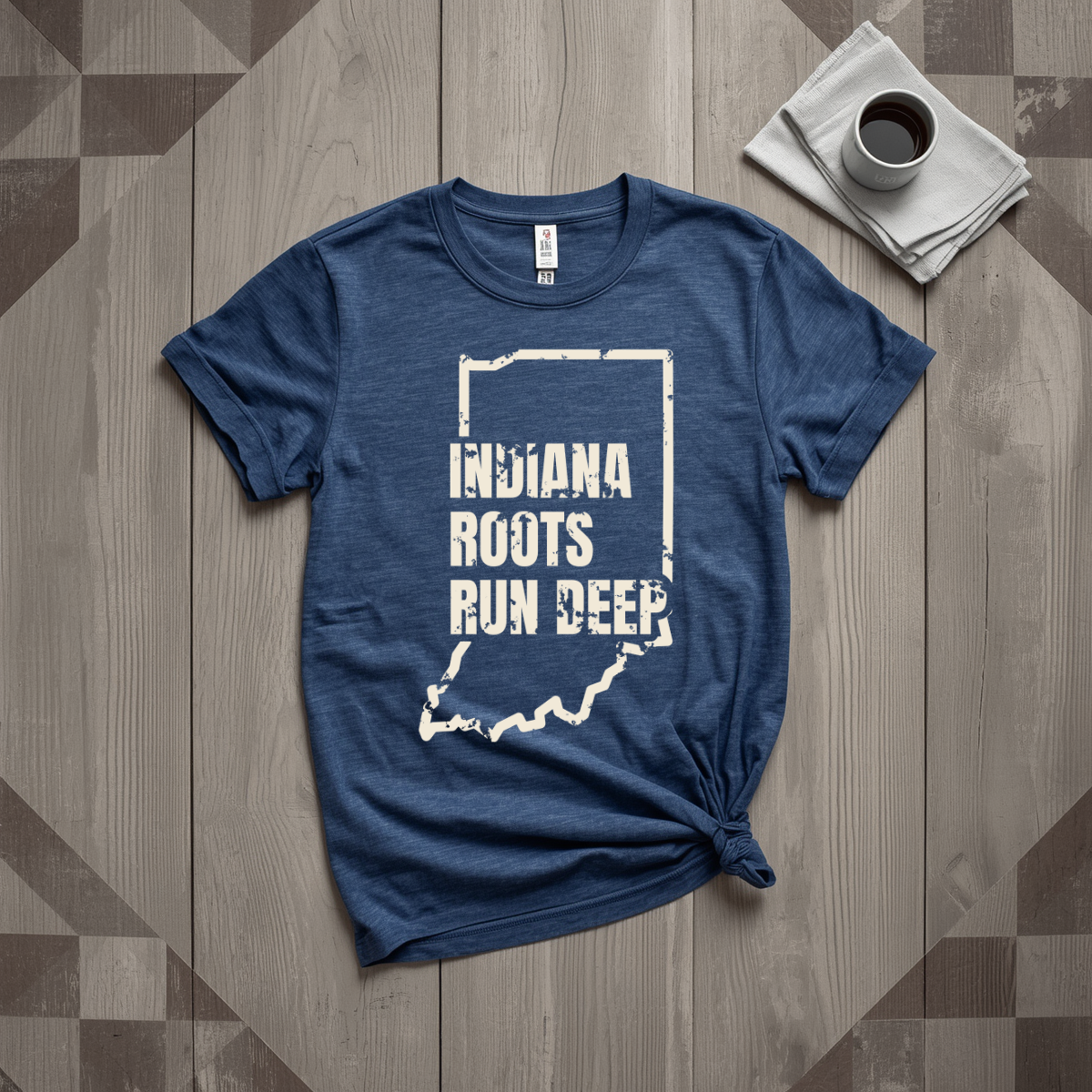 Indiana Roots Run Deep tee in heather navy with cream print, laid flat on weathered wood