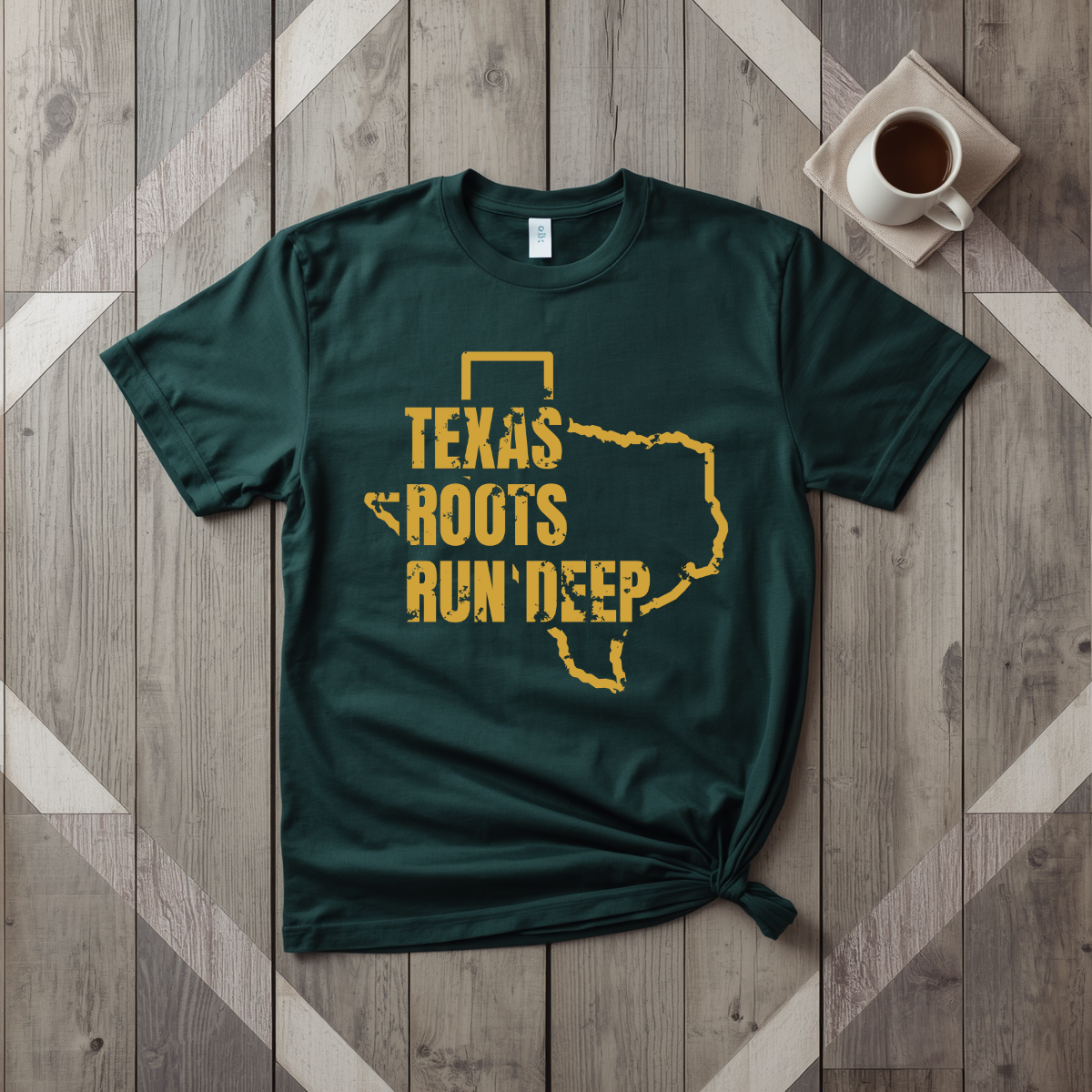 Texas Roots Run Deep tee in forest green with mustard print, laid flat on weathered wood