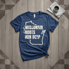 Wisconsin Roots Run Deep tee in heather navy with cream print, laid flat on weathered wood